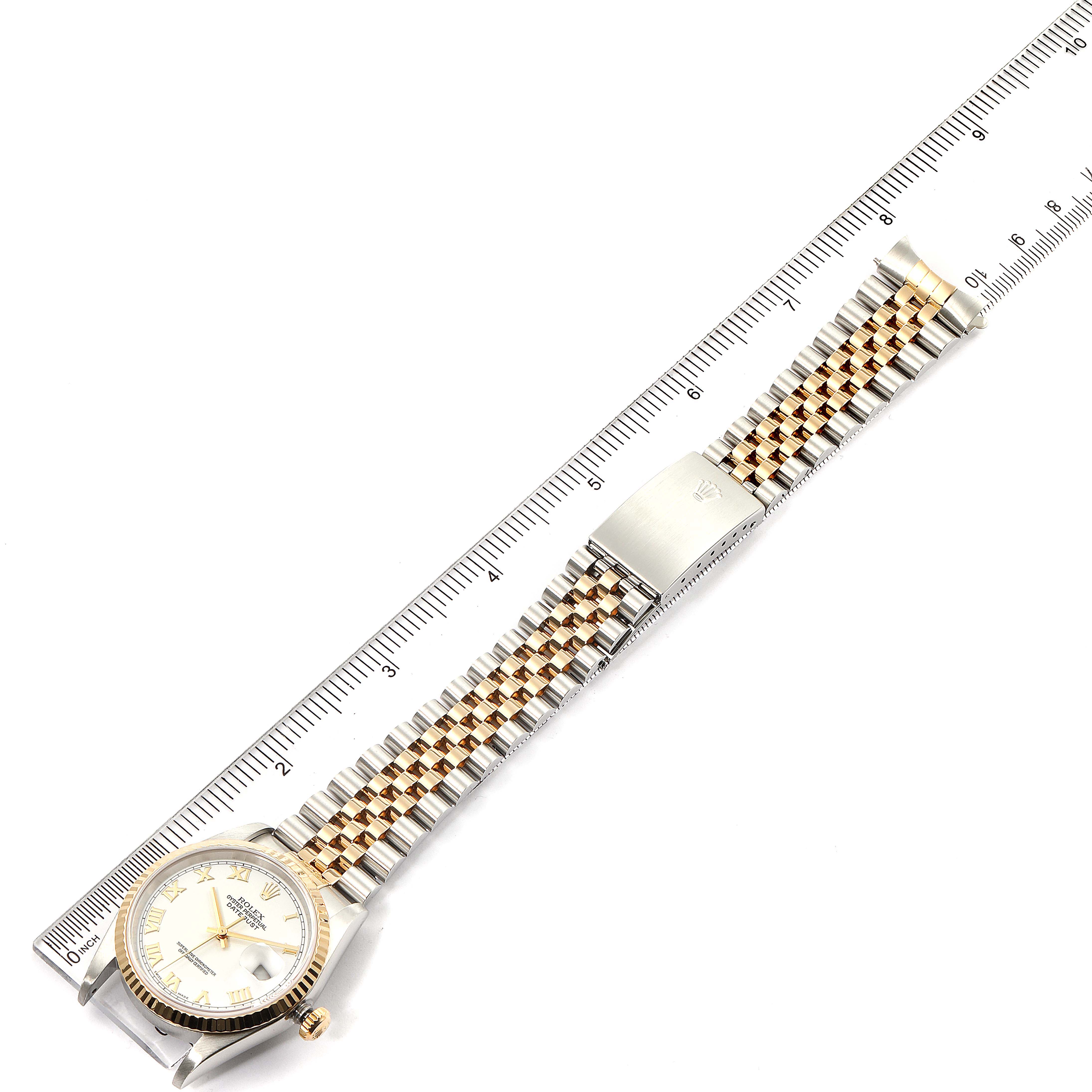 The image shows a Rolex Datejust 16233 Men's Steel and Gold (two tone) White Dial 16233 Men's Steel and Gold (two tone) White Dial watch laid flat next to a ruler, displaying the face, bezel, crown, band, and clasp.