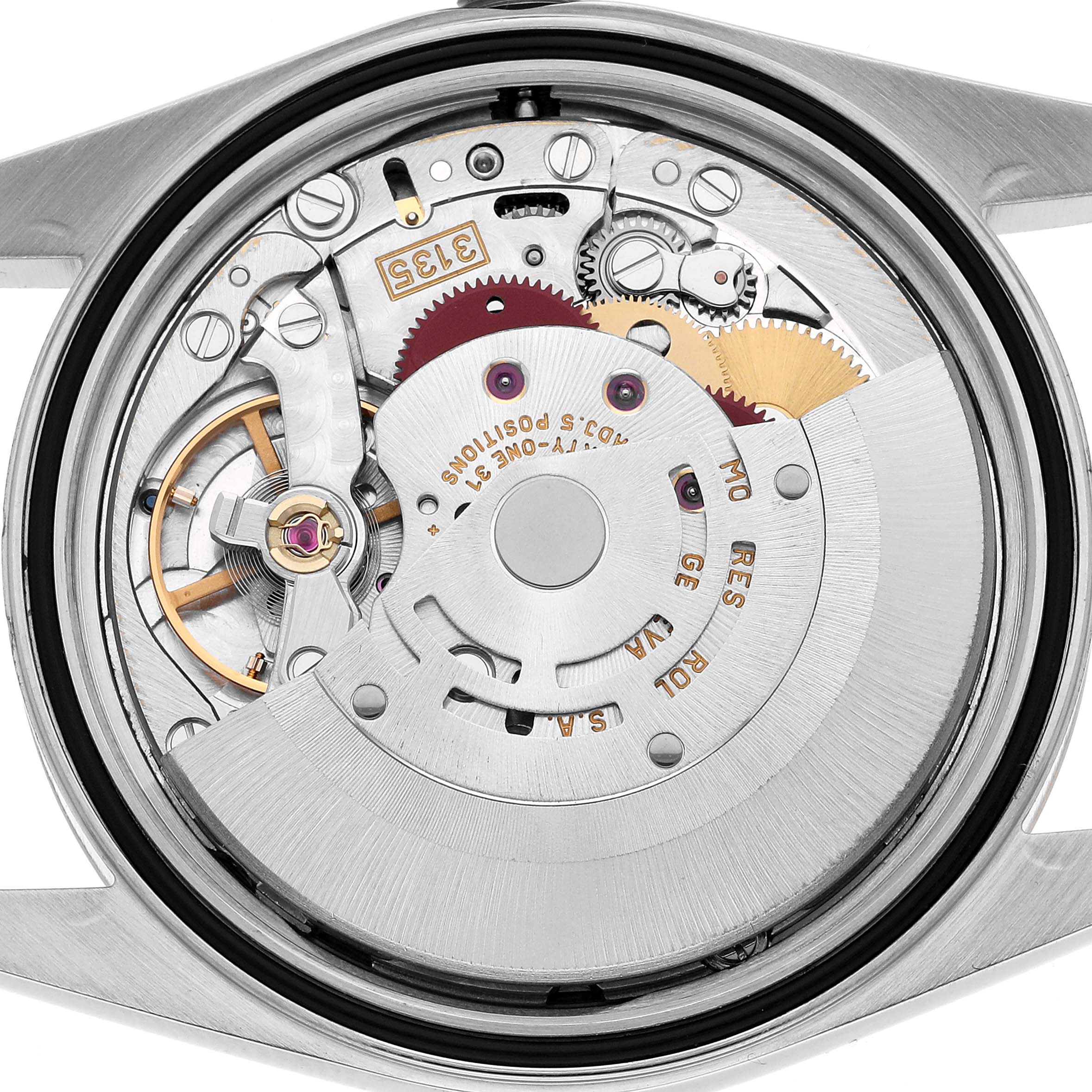 The image shows a close-up of the movement of a Rolex Datejust 16233 Men's Steel and Gold (two tone) White Dial, highlighting the intricate gears and rotor.