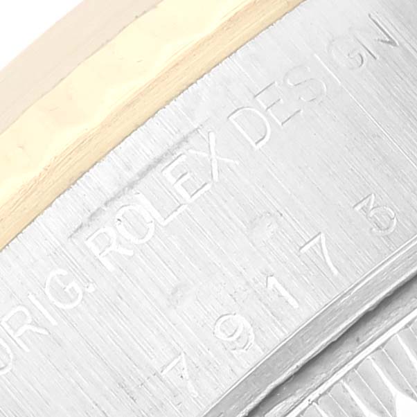 This close-up angle shows the engraved edge of the case for the Rolex Datejust 79173 Women's Steel and Gold (two tone) White Dial 79173 Women's Steel and Gold (two tone) White Dial watch, highlighting its detailed inscription.