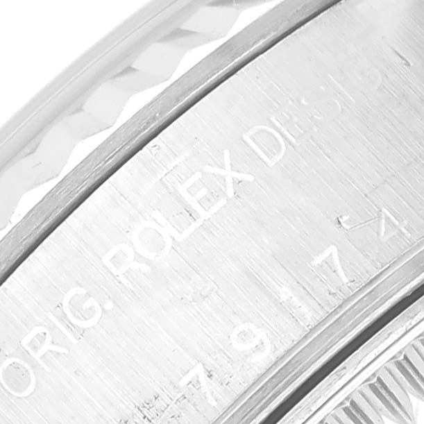 This image shows an angled close-up of the bezel and engraved edge of a Rolex Datejust 79174 Women's Stainless Steel Pink Dial 79174 Women's Stainless Steel Pink Dial watch.