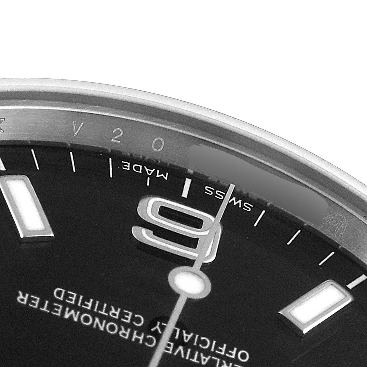 This close-up image of the Rolex Explorer 114270 Men
s Stainless Steel Black Dial 114270 Men
s Stainless Steel Black Dial watch shows part of the dial with the "9," "SWISS MADE," and adjacent text.