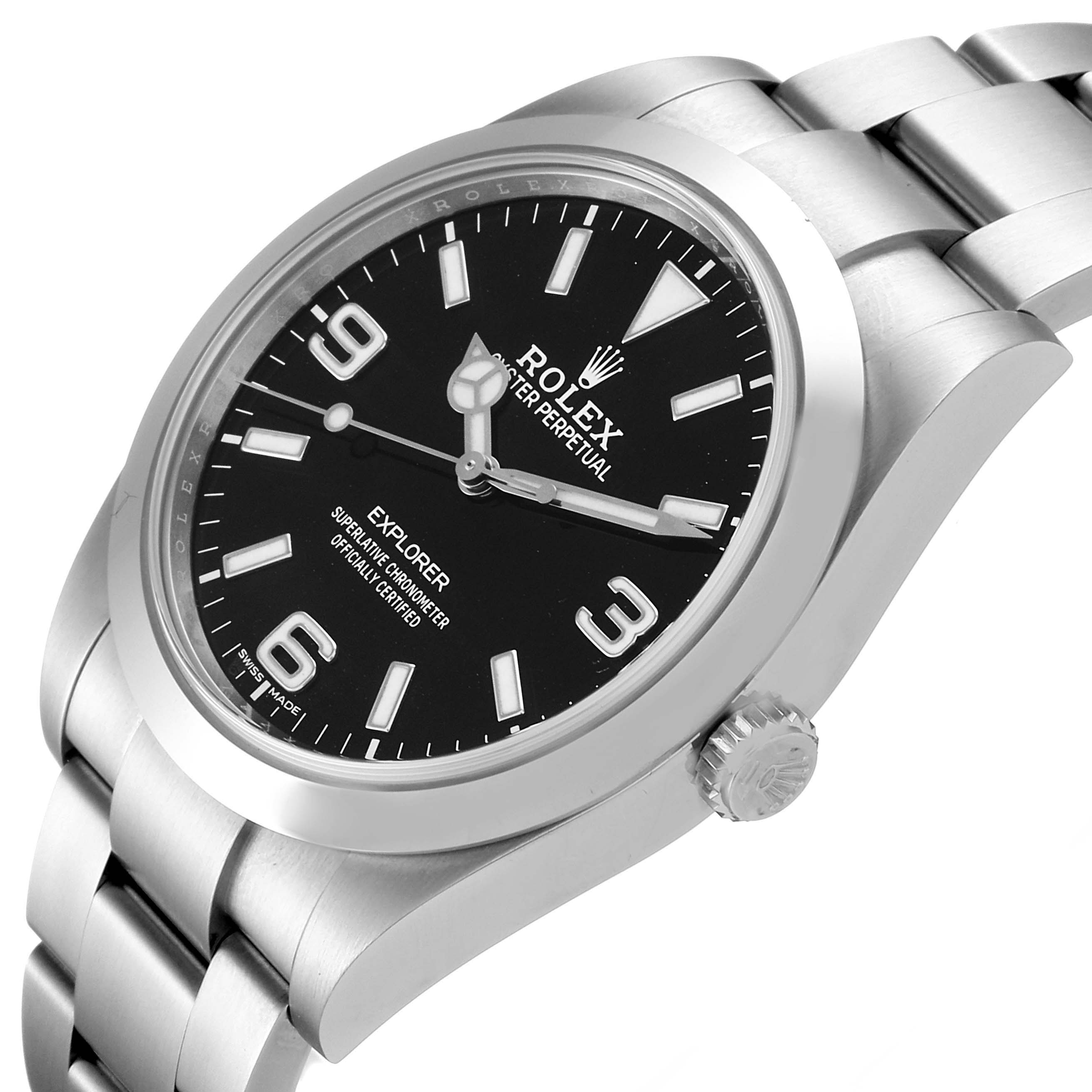 This image shows a Rolex Explorer 214270 Men
s Stainless Steel Black Dial 214270 Men
s Stainless Steel Black Dial watch from an oblique angle, highlighting the face, crown, and part of the metal bracelet.