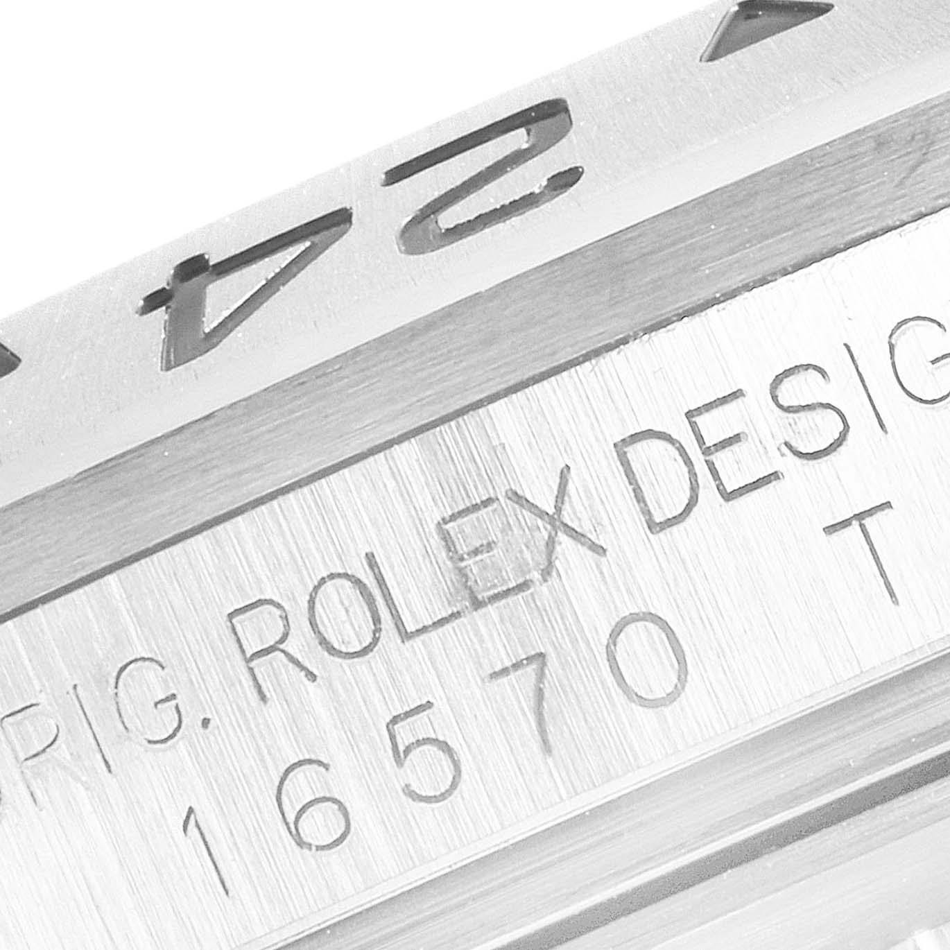 The image shows a close-up of the side of the bezel and case of a Rolex Explorer 16570 Men
s Stainless Steel White Dial 16570 Men
s Stainless Steel White Dial model, highlighting engraved details.