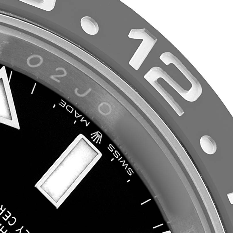 The image shows a close-up of the bezel and dial edge of the Rolex GMT-Master 126710 Men's Stainless Steel Black Dial, highlighting the "12" marker and "Swiss Made."