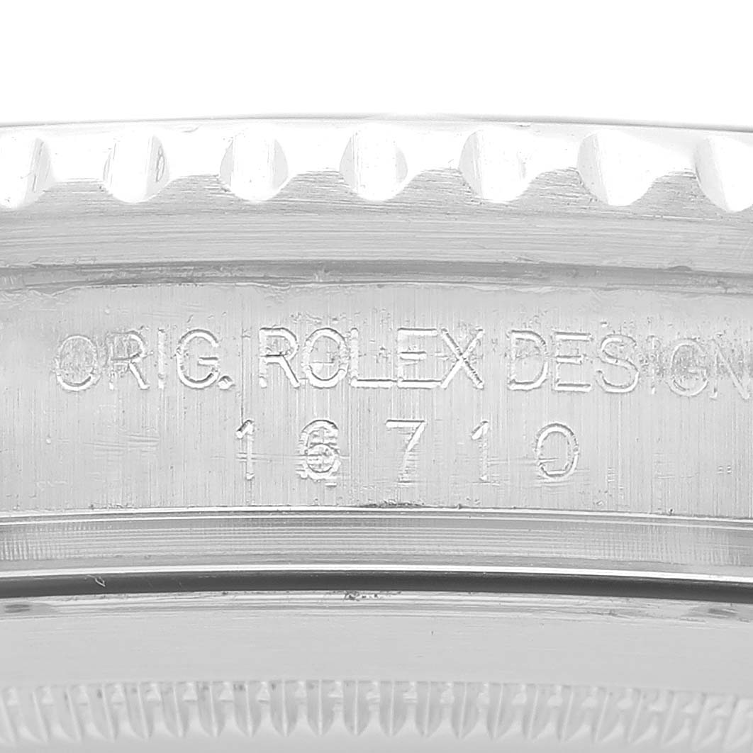 This image shows an angled close-up of the case side of a Rolex GMT-Master 16710 Men's Stainless Steel Silver Dial 16710 Men's Stainless Steel Silver Dial watch with the engraved model number 16710.