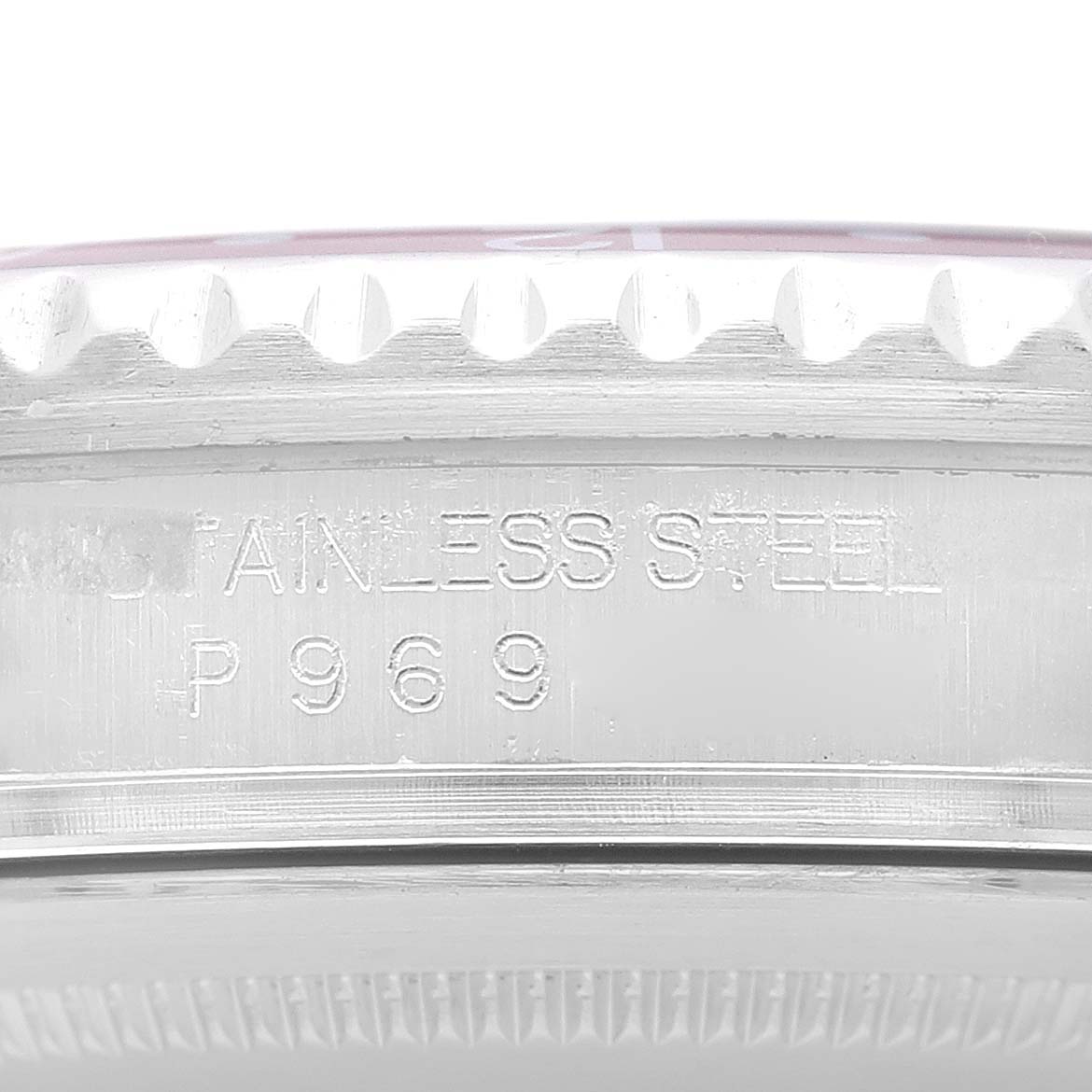 This close-up image of the Rolex GMT-Master 16710 Men's Stainless Steel Silver Dial 16710 Men's Stainless Steel Silver Dial watch shows the side engraving and part of the bezel.