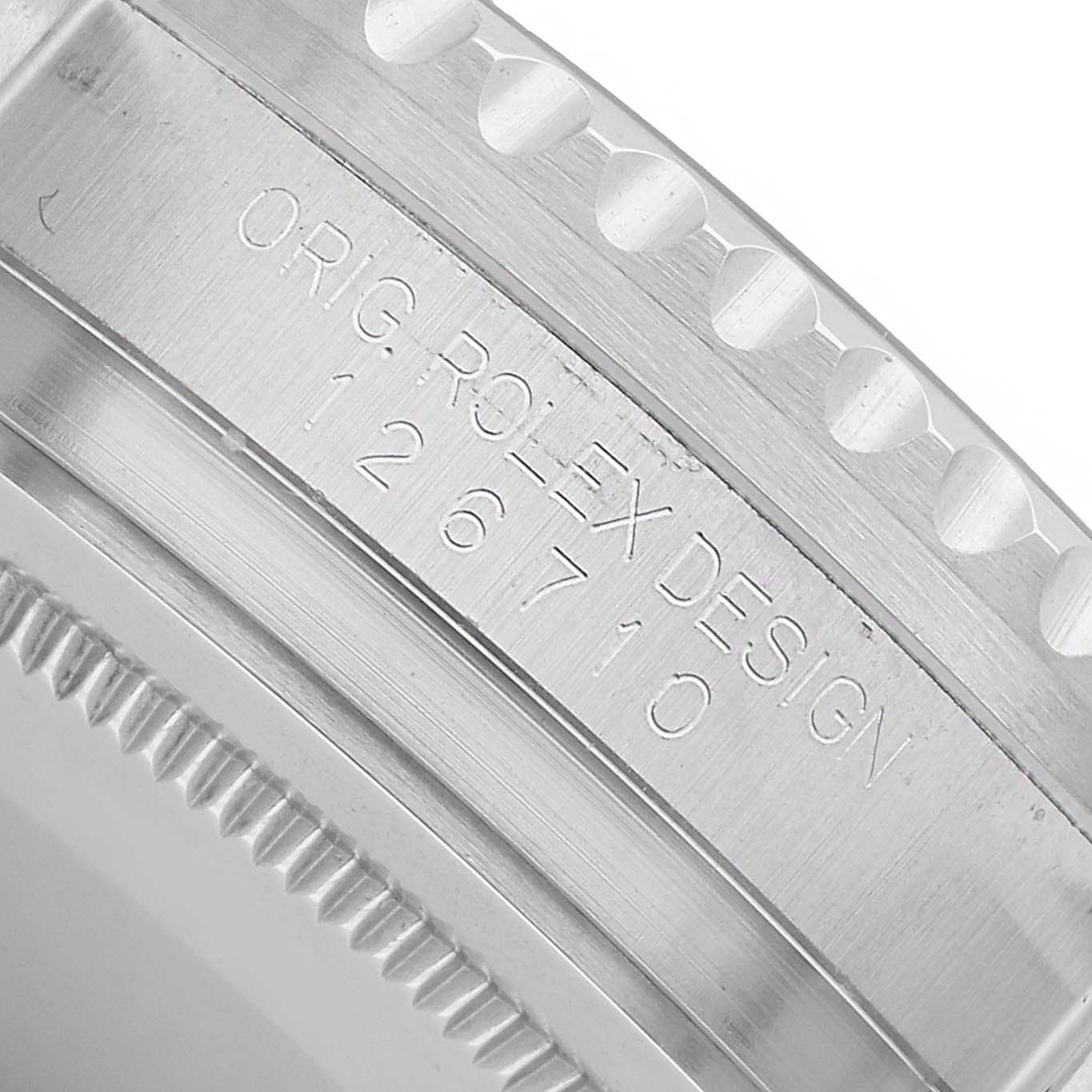 The image shows a close-up of the side engraving and bezel teeth on a Rolex GMT-Master 126710 Men's Stainless Steel Black Dial watch.