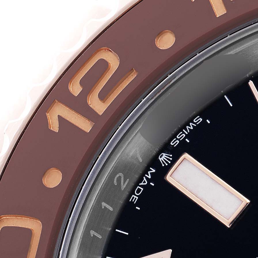 The image shows a close-up of the Rolex GMT-Master 126711 Men's Steel and Gold (two tone) Black Dial bezel, focusing on the brown ceramic insert and part of the watch face.