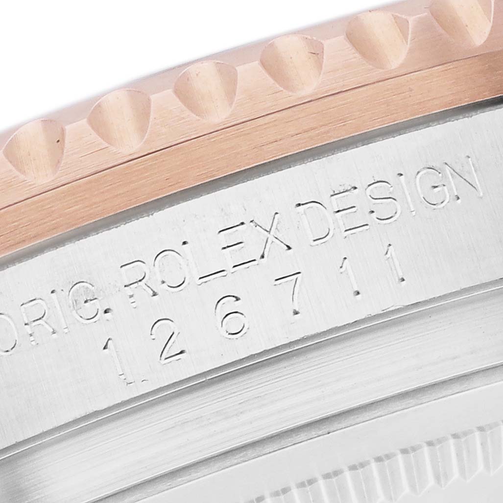 The image shows the side of the Rolex GMT-Master 126711 Men's Steel and Gold (two tone) Black Dial model, highlighting the bezel edge and engraved model number.