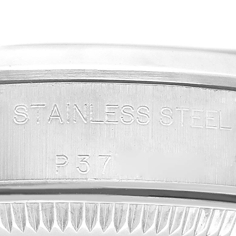 This image shows a close-up of the side of a Rolex Oyster Perpetual 76080 Women
s Stainless Steel Blue Dial 76080 Women
s Stainless Steel Blue Dial watch, highlighting the "STAINLESS STEEL" engraving.
