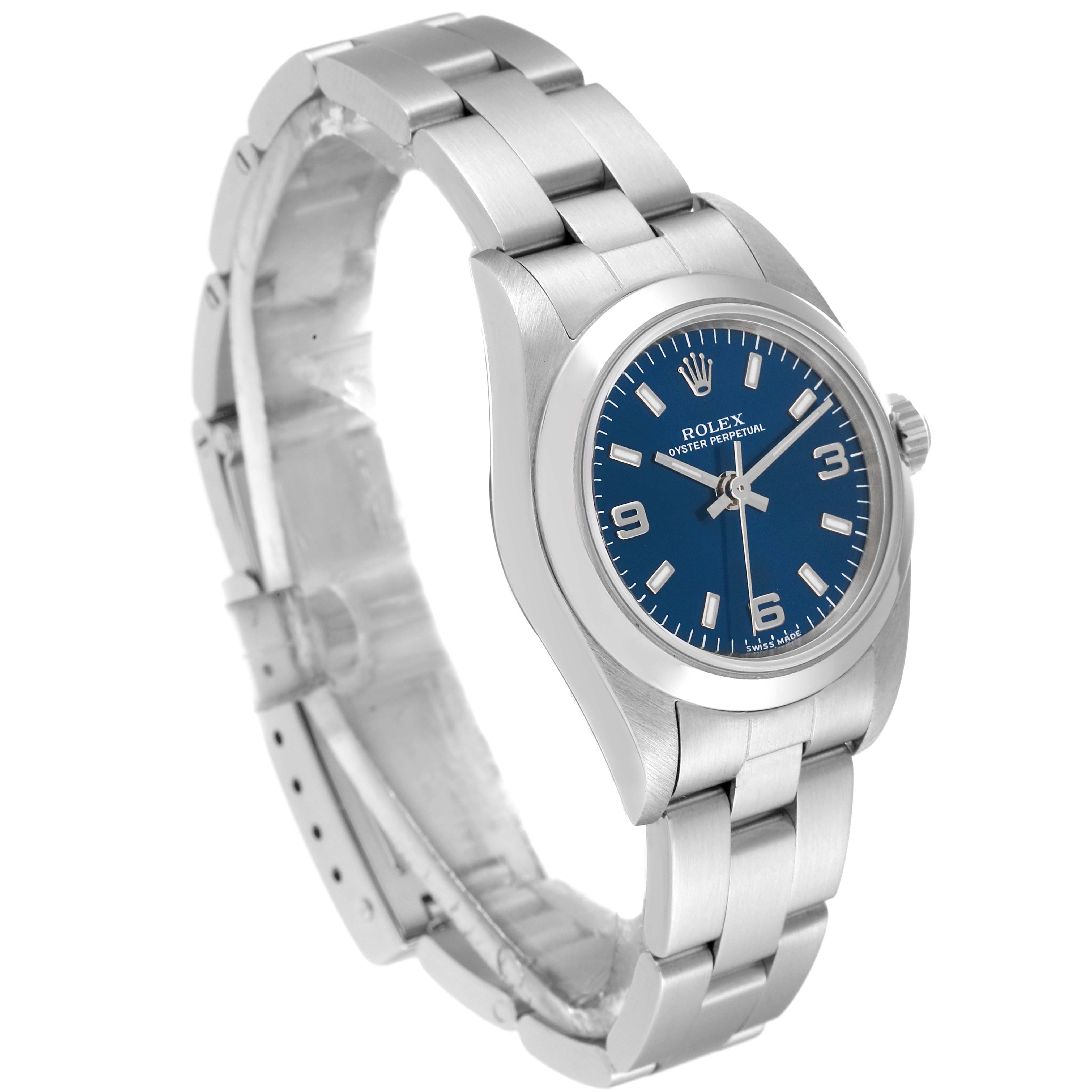 The Rolex Oyster Perpetual 76080 Women
s Stainless Steel Blue Dial 76080 Women
s Stainless Steel Blue Dial watch is shown from a slight side angle, highlighting its blue dial, crown, and metal bracelet.