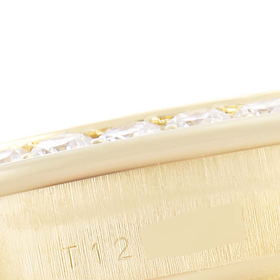 The image shows a close-up of the bezel of a Rolex Pearlmaster 69298 Women's Yellow Gold Mother of Pearl Dial 69298 Women's Yellow Gold Mother of Pearl Dial watch, highlighting the diamonds and part of the engraved serial number.