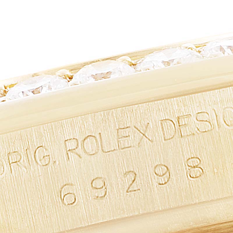 This close-up image shows the engraved case side and bezel with gemstones of a Rolex Pearlmaster 69298 Women's Yellow Gold Mother of Pearl Dial 69298 Women's Yellow Gold Mother of Pearl Dial watch.