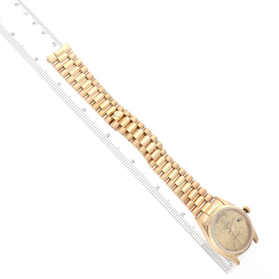 The image shows a Rolex President 18238 Men's Yellow Gold Champagne Dial watch at an angled top view, displaying the bracelet and face alongside a ruler.
