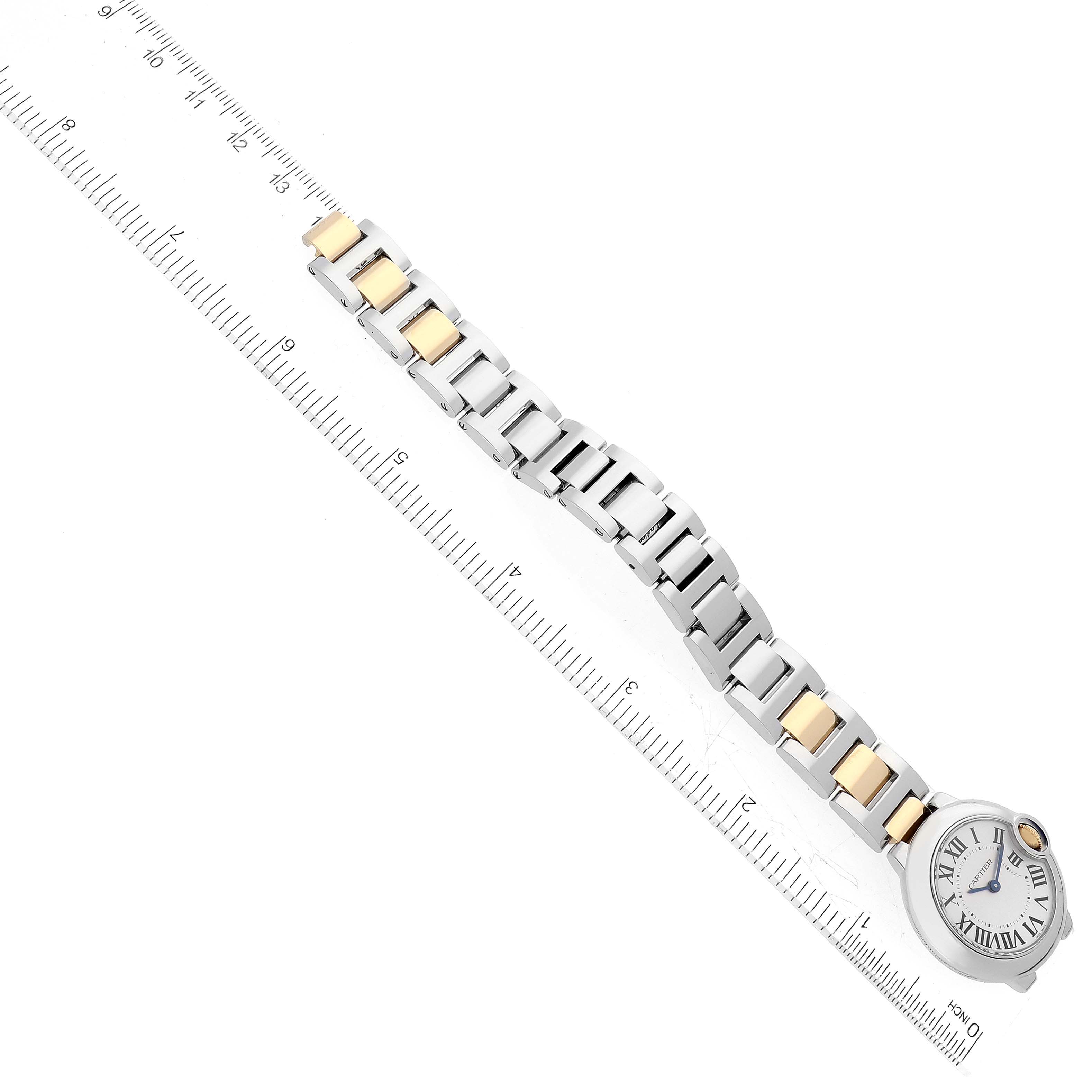 The Cartier Ballon Bleu W2BB0010 Women's Steel and Gold (two tone) Silver Dial W2BB0010 Women's Steel and Gold (two tone) Silver Dial watch is photographed from above, showing part of the dial and the entire bracelet against a ruler.