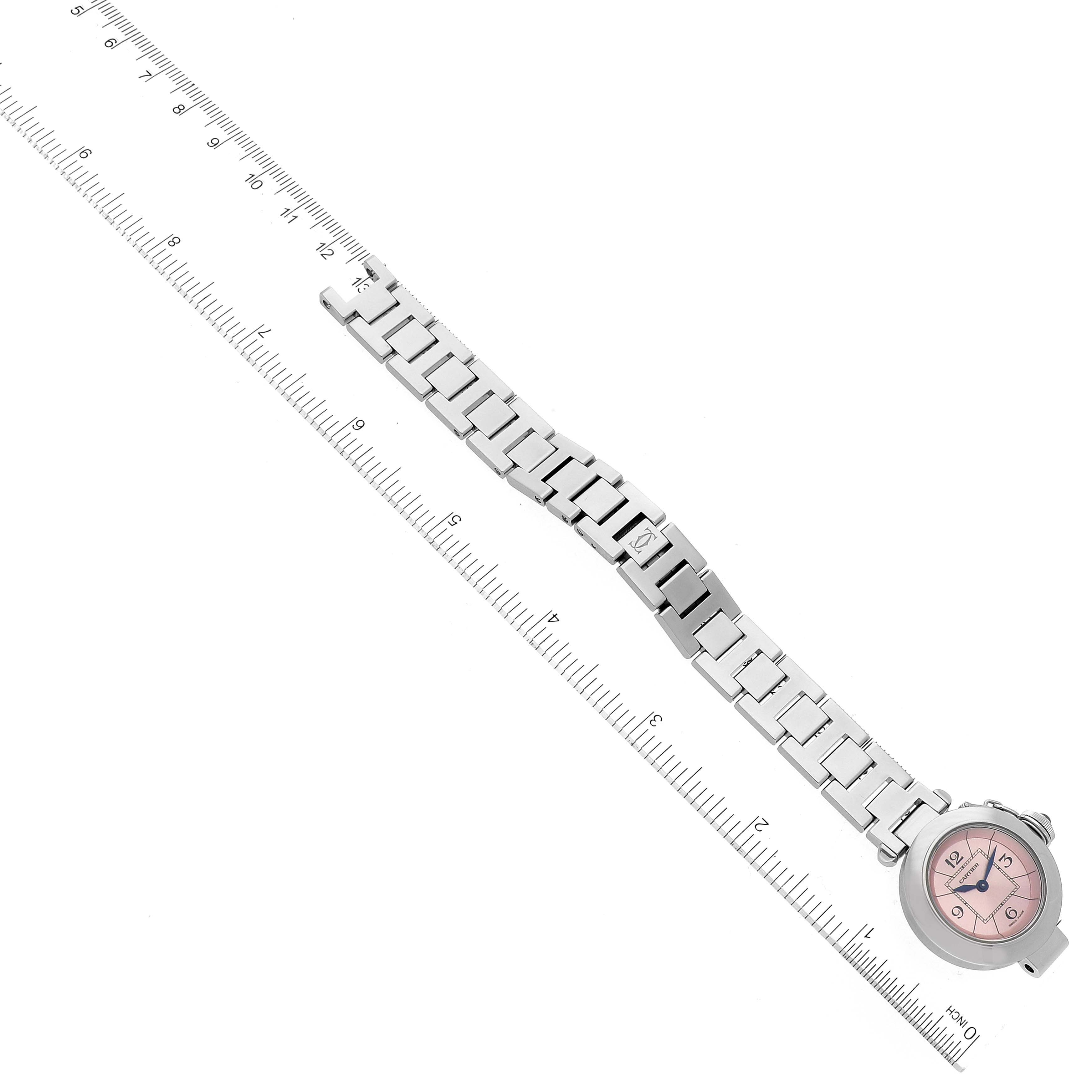 This image shows a Cartier Pasha W3140008 Women's Stainless Steel Pink Dial W3140008 Women's Stainless Steel Pink Dial watch from a top-down angle, highlighting its bracelet and pink dial, next to a measurement ruler.
