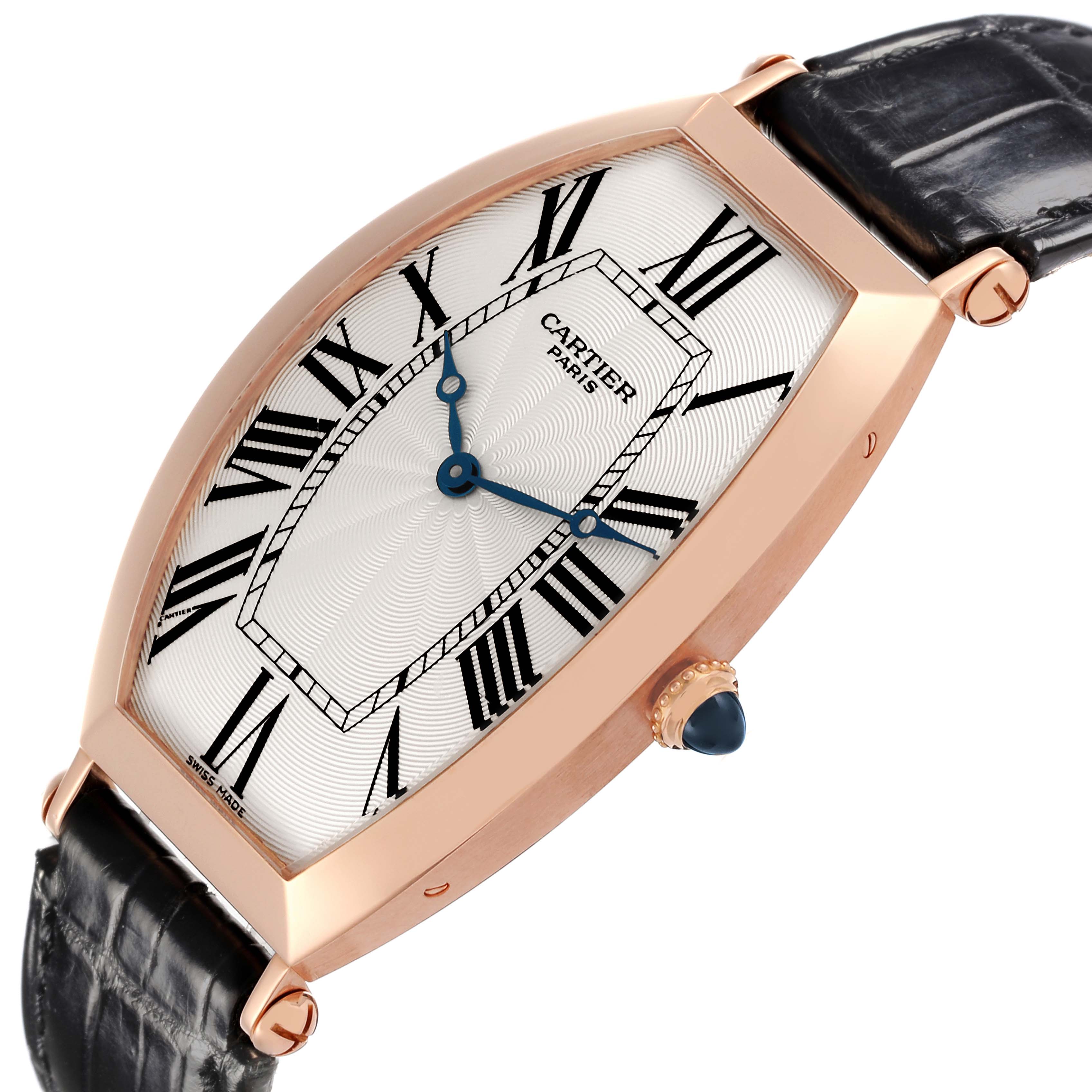 The Cartier Tonneau W1546251 Men
s Rose Gold Silver Dial W1546251 Men
s Rose Gold Silver Dial watch is shown at a tilted angle, highlighting the face, crown, and part of the leather strap.