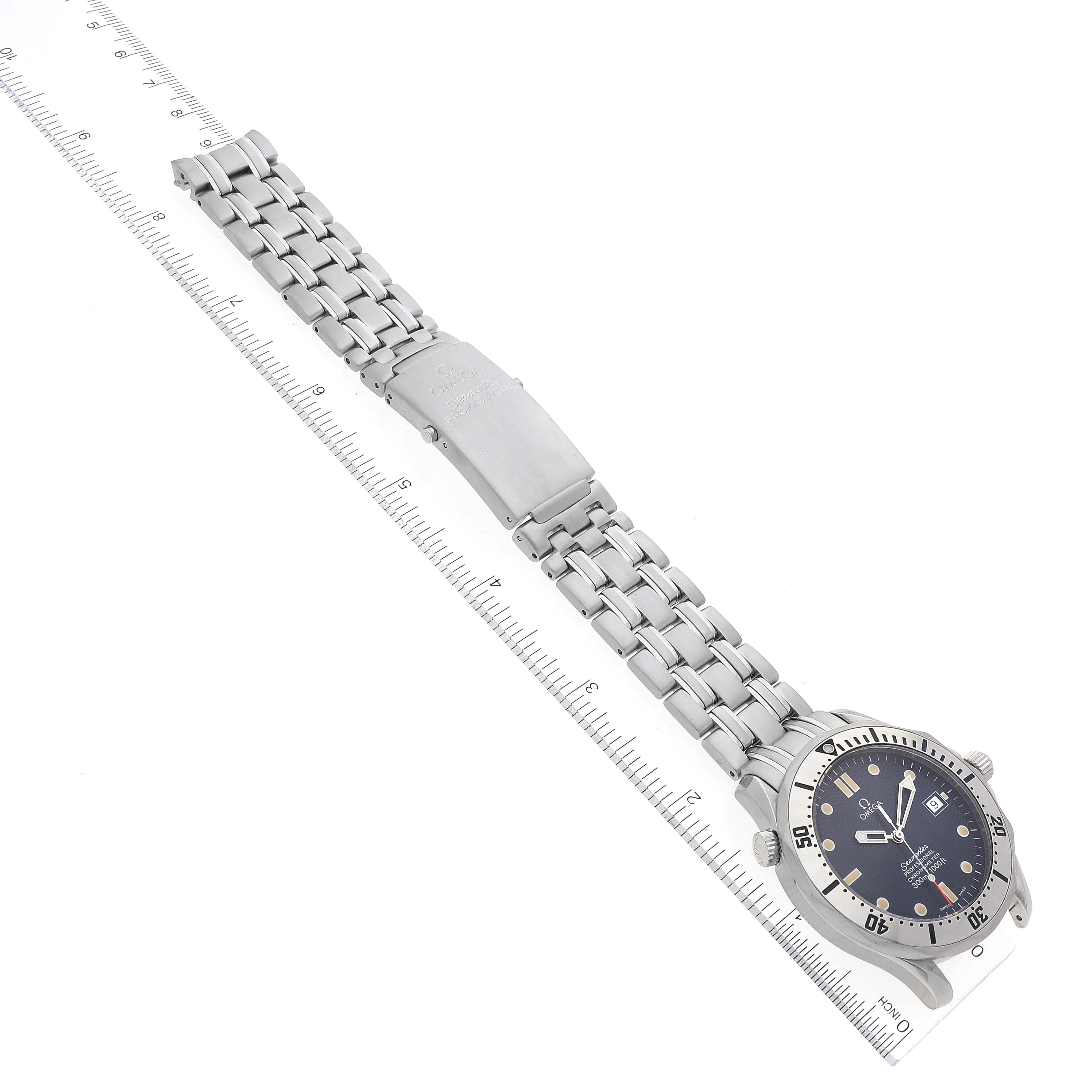 The image displays an Omega Seamaster 2532.80.00 Men's Stainless Steel Blue Dial 2532.80.00 Men's Stainless Steel Blue Dial watch laid flat with its band extended and aligned along a measuring ruler.