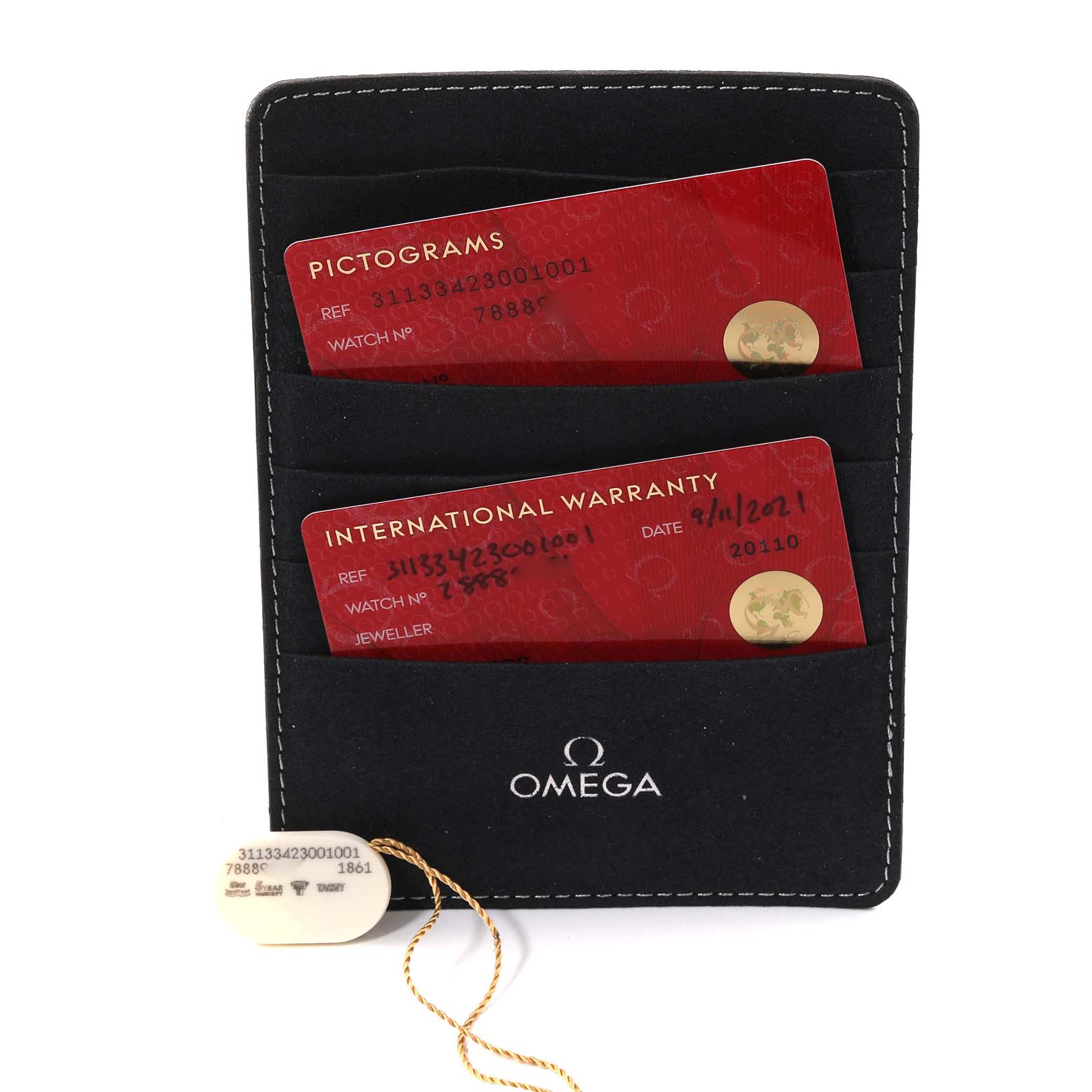 The image shows two red cards in a black cardholder, labeled "Pictograms" and "International Warranty," along with the logo for Omega Speedmaster 311.33.42.30.01.001 Men
s Stainless Steel Black Dial 311.33.42.30.01.001 Men
s Stainless Steel Black Dial.