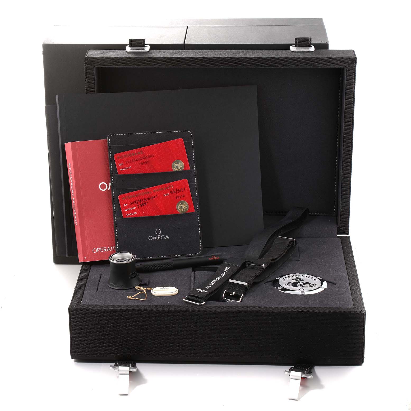 The image shows an Omega Speedmaster 311.33.42.30.01.001 Men
s Stainless Steel Black Dial 311.33.42.30.01.001 Men
s Stainless Steel Black Dial watch box and accessories, including cards, straps, a loupe, and a manual, all viewed from the front.