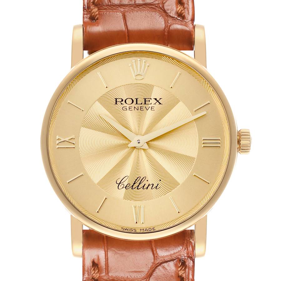 The Rolex Cellini watch is shown from the front, displaying its gold dial, hands, and brown leather strap.