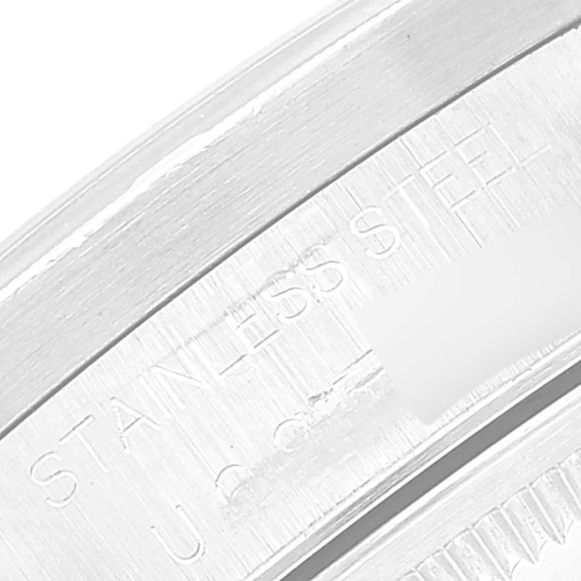 This close-up image shows the "Stainless Steel" engraving on the case back edge of a Rolex Date 15210 Men's Stainless Steel Silver Dial 15210 Men's Stainless Steel Silver Dial model.