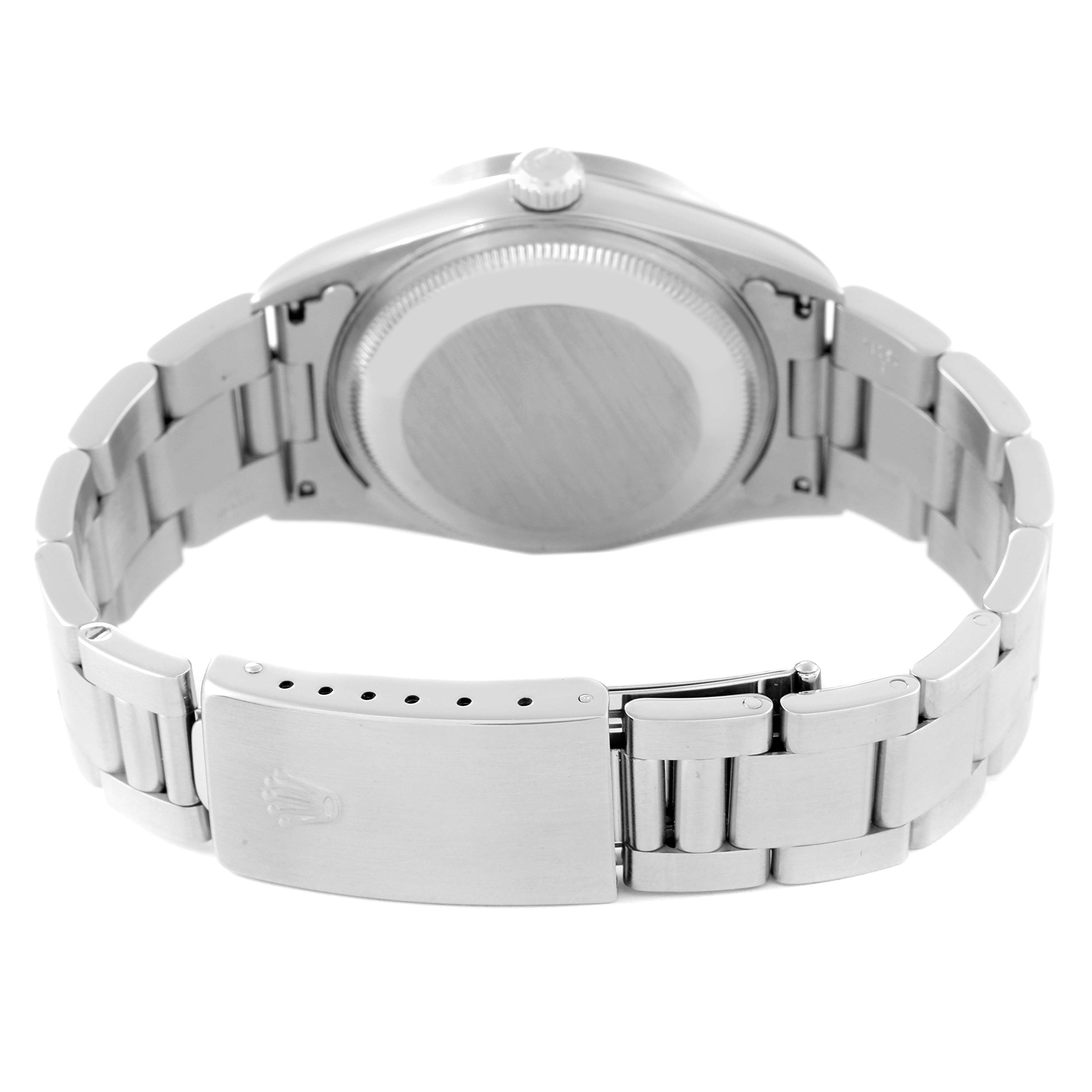 This image shows the back side of a Rolex Date 15210 Men's Stainless Steel Silver Dial 15210 Men's Stainless Steel Silver Dial model watch, highlighting the watch case and metal bracelet with its clasp.