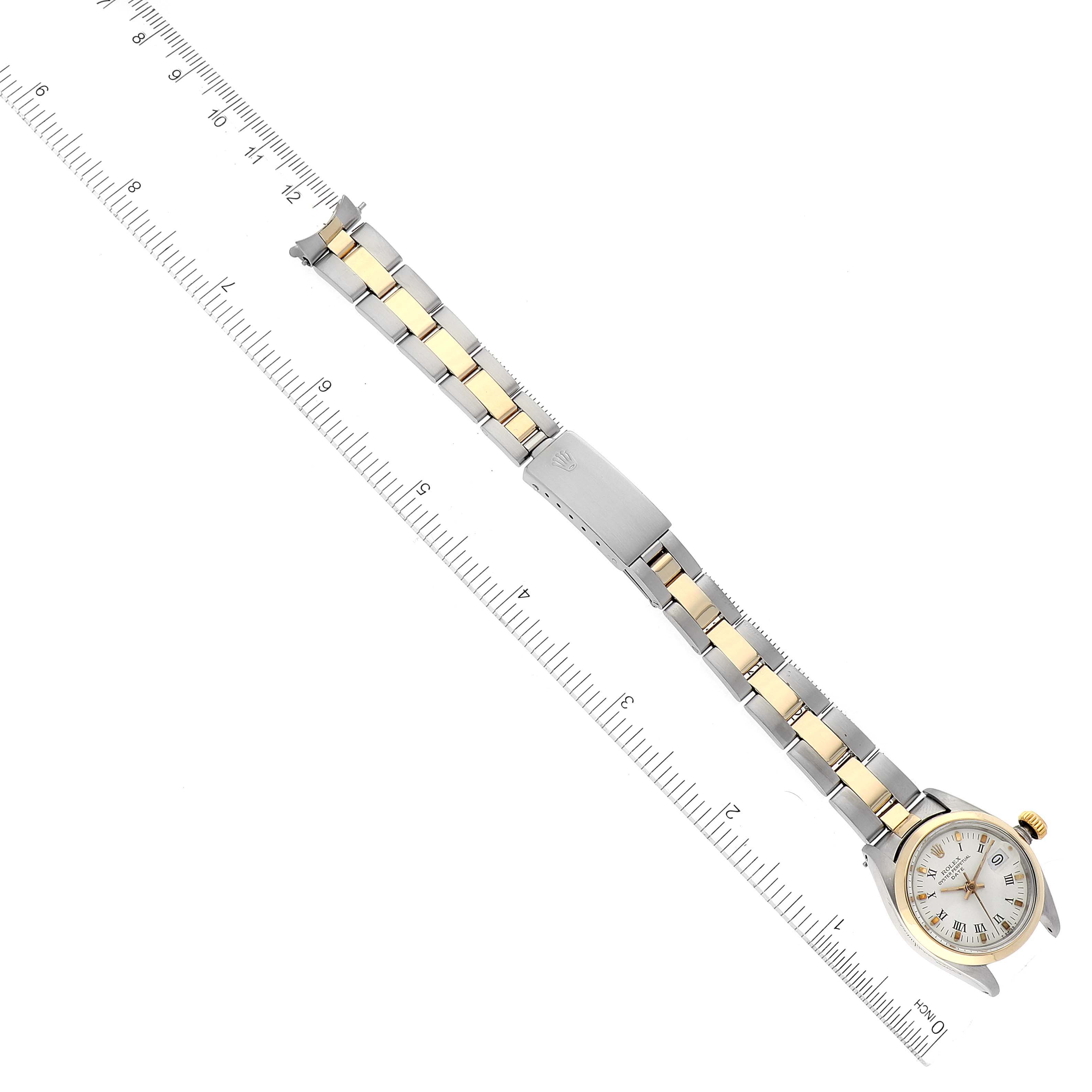 The image shows a Rolex Date 6916 Women's Steel and Gold (two tone) White Dial 6916 Women's Steel and Gold (two tone) White Dial model watch, laid flat and measured with a ruler, displaying the full bracelet and face.