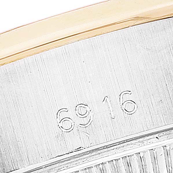 This close-up image shows the caseback engraving with the model number "6916" of a Rolex Date 6916 Women's Steel and Gold (two tone) White Dial 6916 Women's Steel and Gold (two tone) White Dial watch.