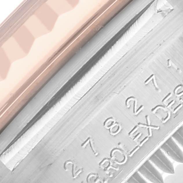 The image shows a close-up of a Rolex Datejust, focusing on the bezel and edge of the engraved inner case.