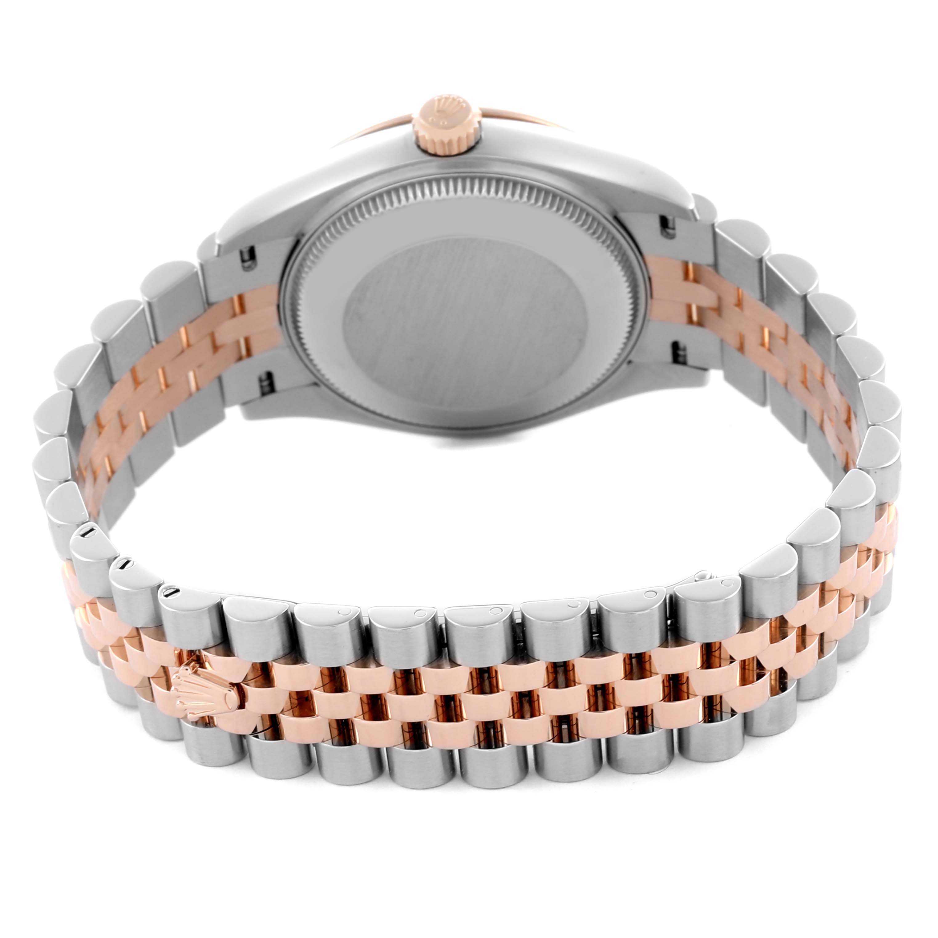 The Rolex Datejust watch is shown from the back, displaying the case back and two-tone bracelet.