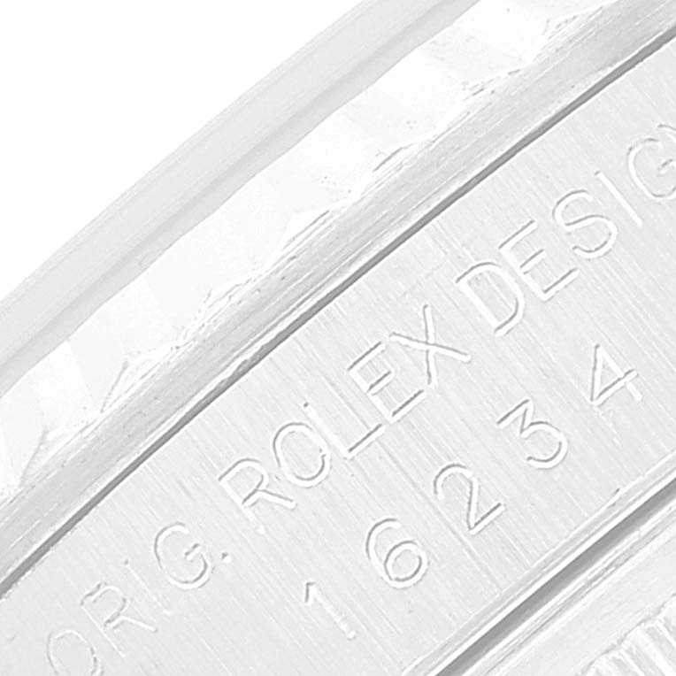 The image shows a close-up of the engravings on the side of a Rolex Datejust 16234 Men's Stainless Steel Silver Dial 16234 Men's Stainless Steel Silver Dial model's case, displaying its serial and model numbers.