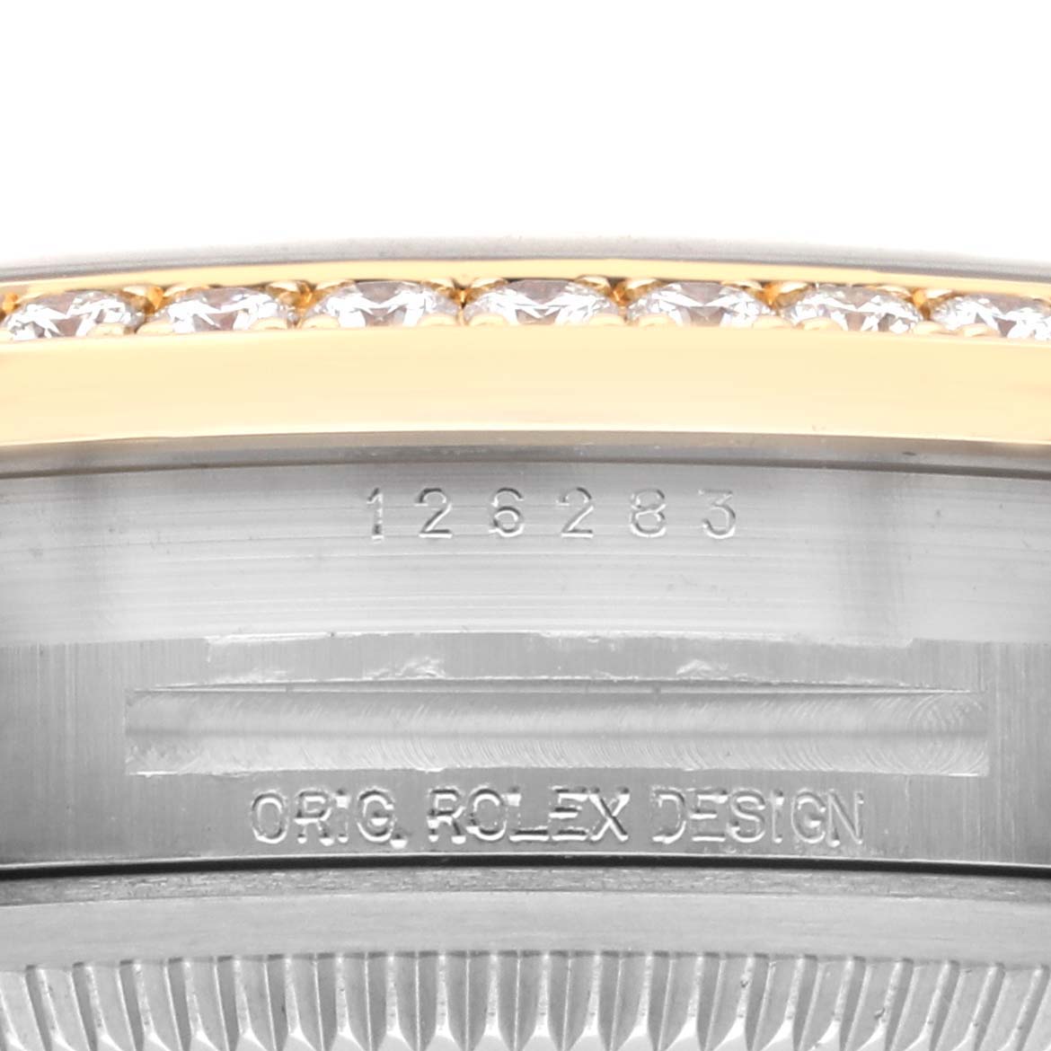 The image shows the side view of a Rolex Datejust 126283RBR Men's Steel and Gold (two tone) Green Dial 126283RBR Men's Steel and Gold (two tone) Green Dial, highlighting the engraved model number and diamond-set bezel.