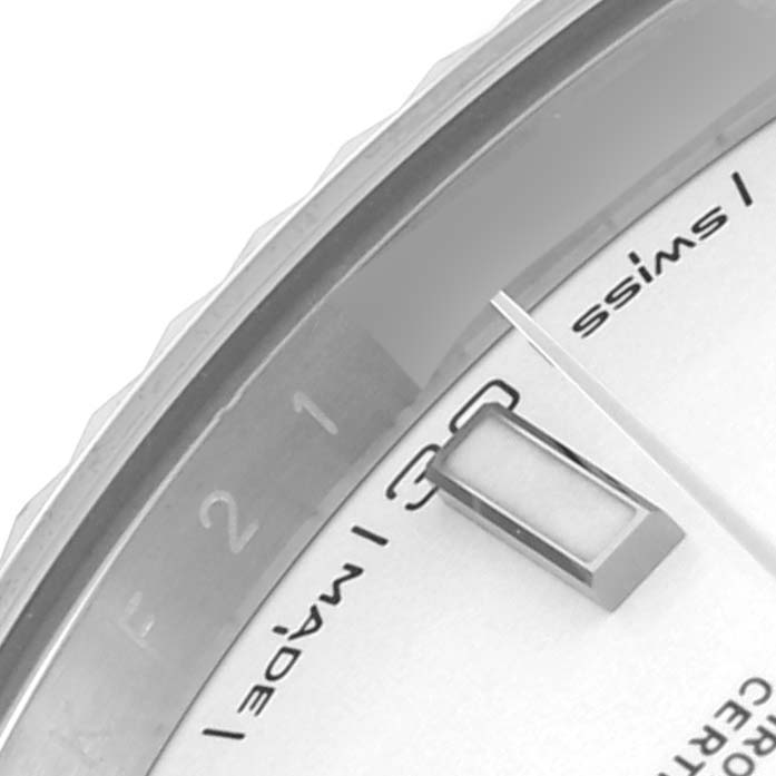 The image shows part of the dial, bezel, and hands of a Rolex Datejust 41 126334 Men
s Stainless Steel White Dial 126334 Men
s Stainless Steel White Dial watch from a close-up angle.