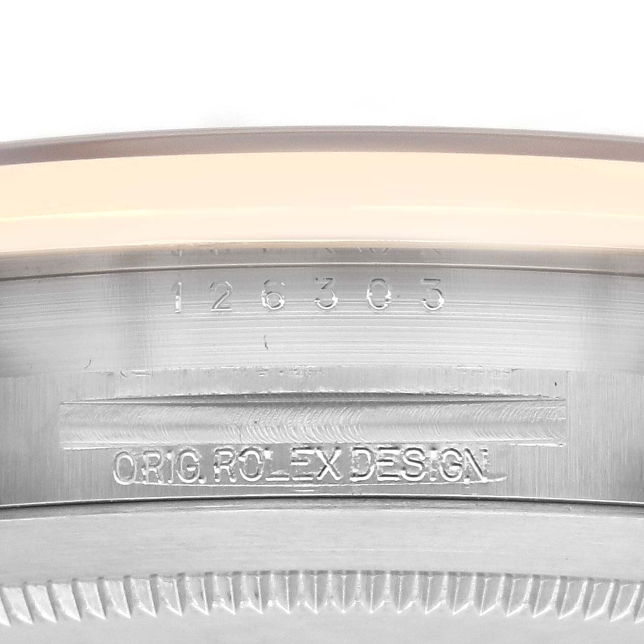 The image shows the side profile of a Rolex Datejust 41 126303 Men's Steel and Gold (two tone) Black Dial 126303 Men's Steel and Gold (two tone) Black Dial, focusing on the engraved bezel and case details.