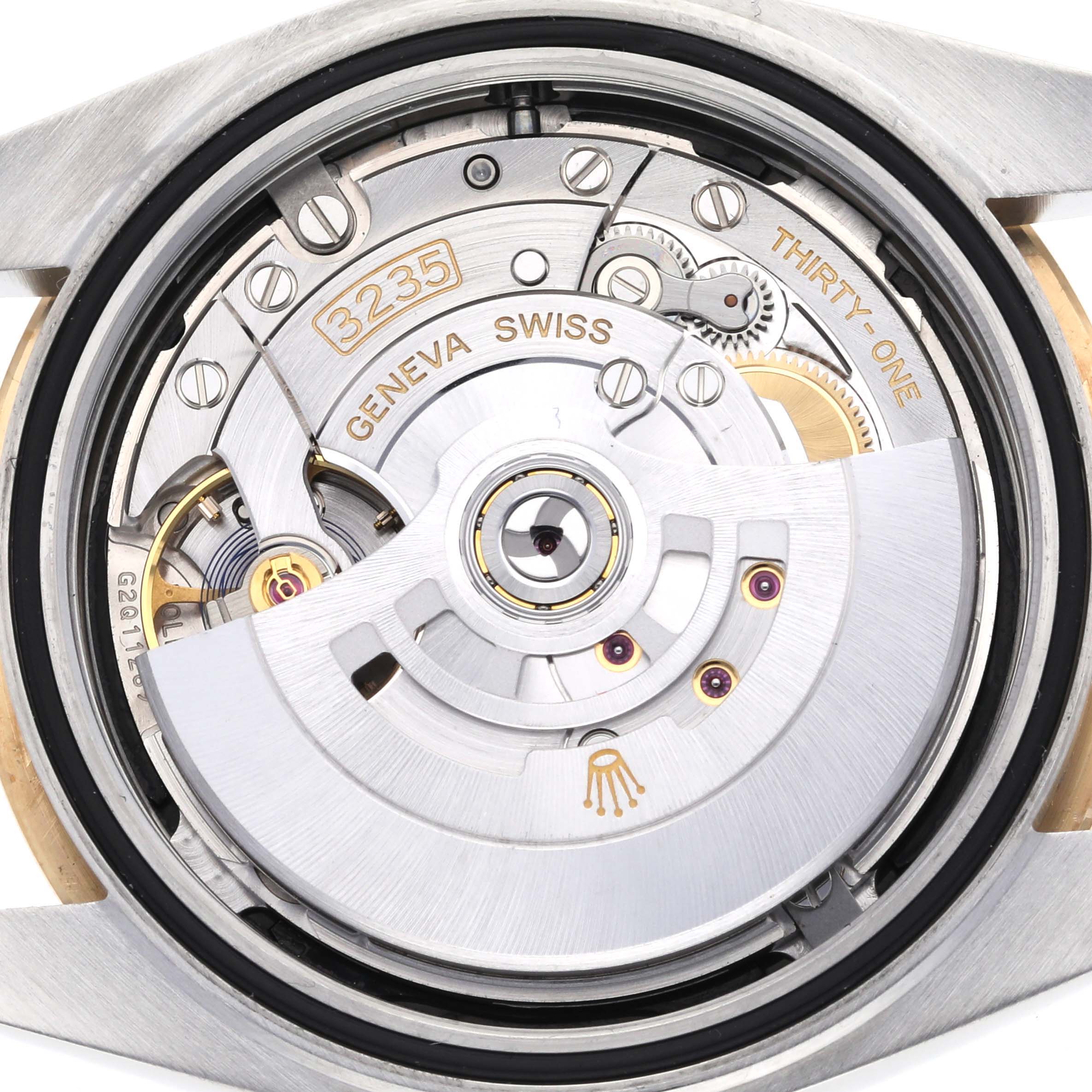 The image shows the movement of the Rolex Datejust 41 126303 Men's Steel and Gold (two tone) Black Dial 126303 Men's Steel and Gold (two tone) Black Dial from the back angle, highlighting the intricate mechanical parts.
