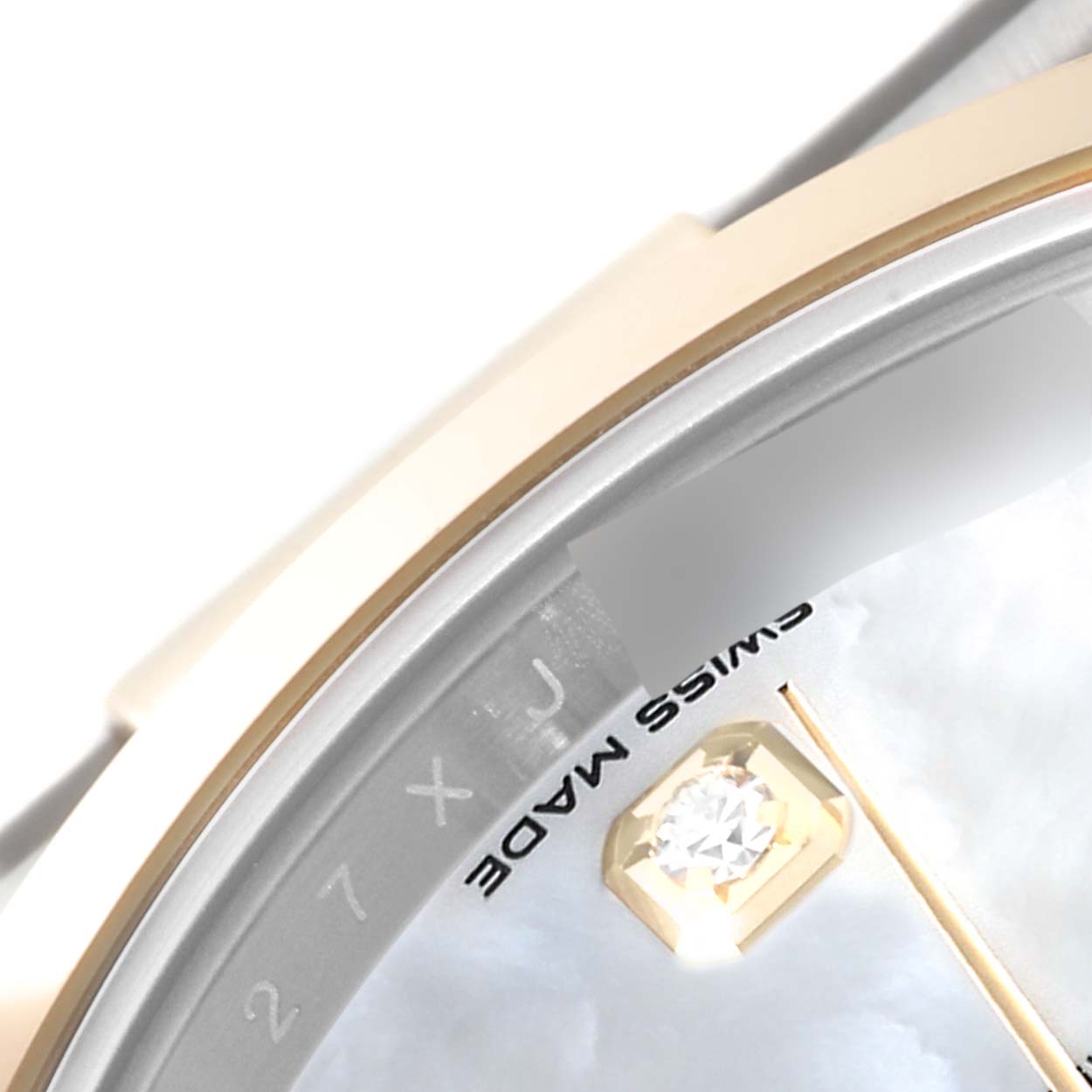 This close-up image of the Rolex Datejust 41 126303 Men's Steel and Gold (two tone) Mother of Pearl Dial 126303 Men's Steel and Gold (two tone) Mother of Pearl Dial watch focuses on part of the dial, showcasing "SWISS MADE" text and a diamond hour marker.