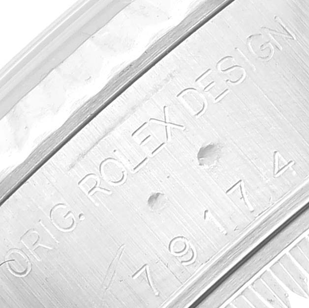 The image shows a close-up of the case edge engraving on a Rolex Datejust 79174 Women's Stainless Steel White Dial 79174 Women's Stainless Steel White Dial watch, displaying the model number and "ORIG. ROLEX DESIGN".