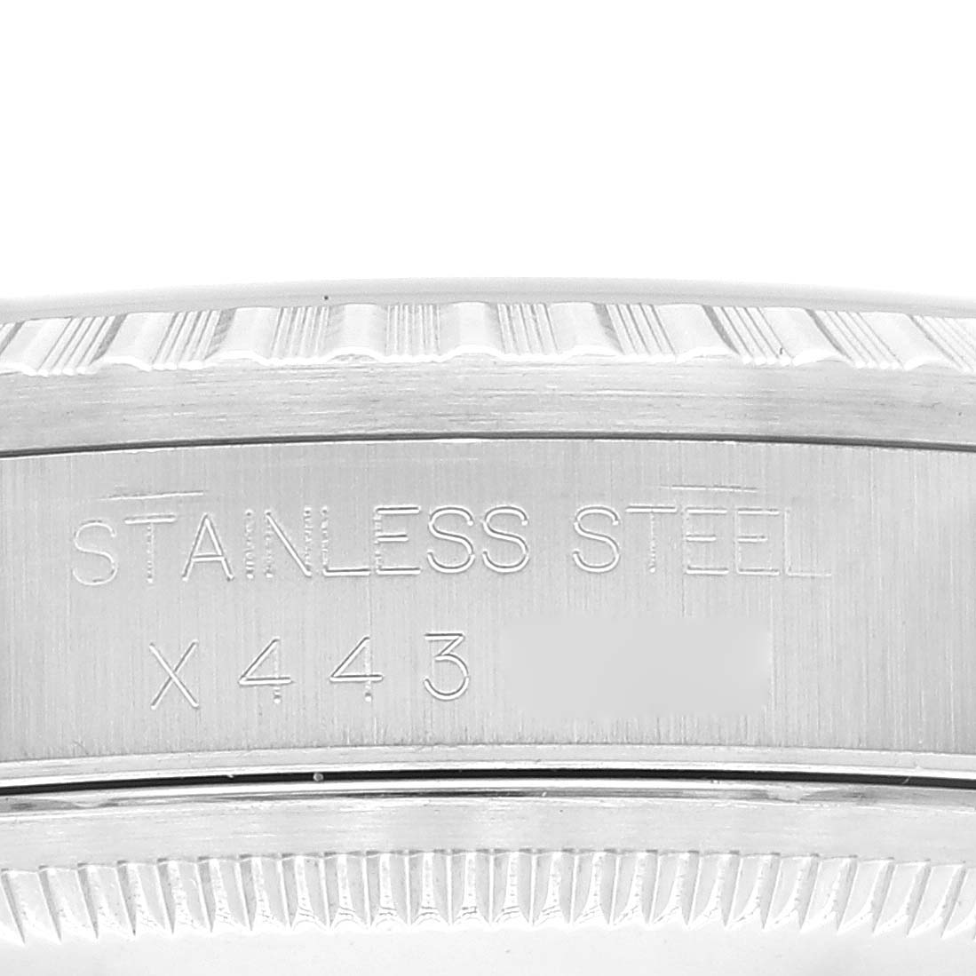This image shows a close-up view of the stainless steel case side of a Rolex Datejust 16220 Men's Stainless Steel Blue Dial 16220 Men's Stainless Steel Blue Dial model, displaying engraved text and serial numbers.