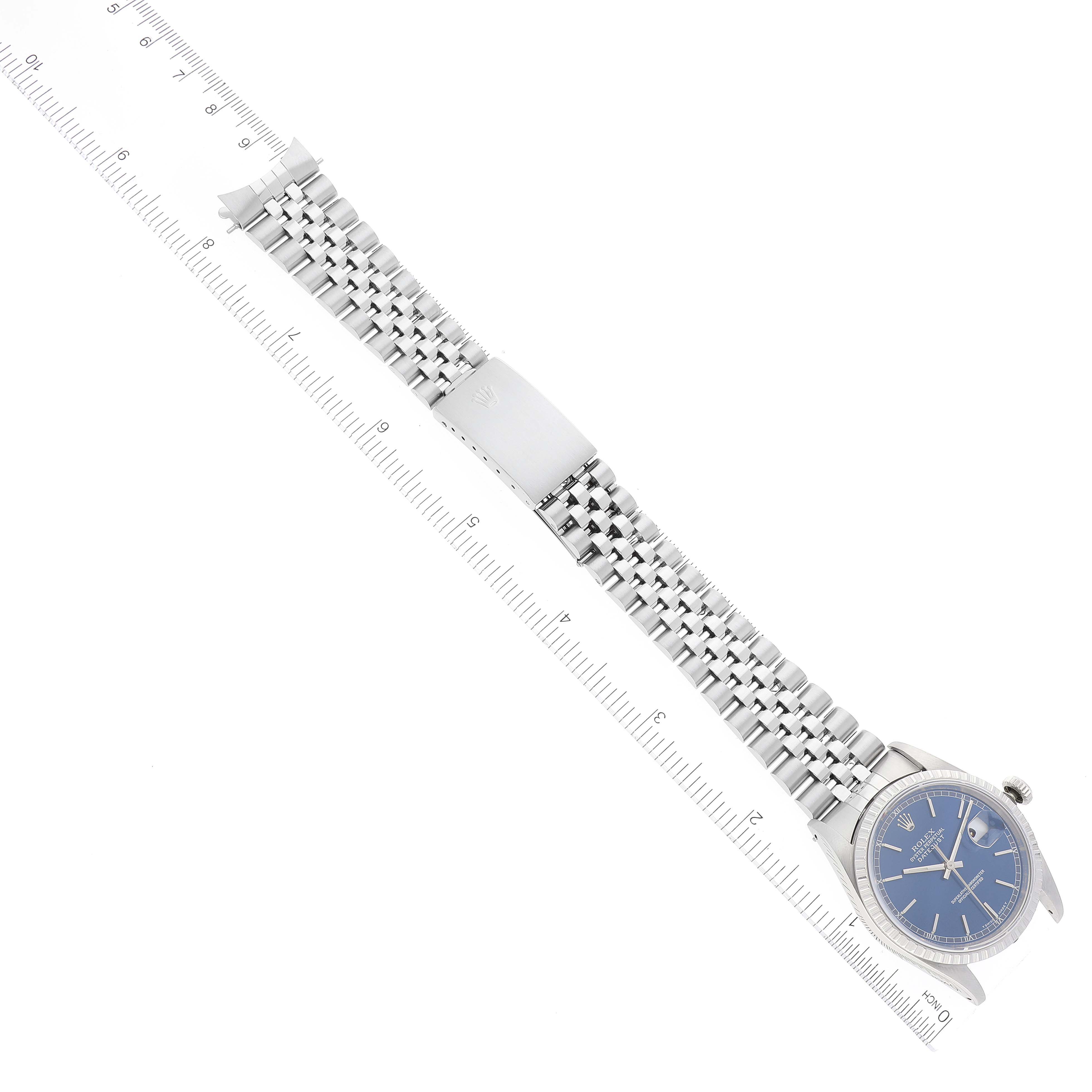 This image shows the Rolex Datejust 16220 Men's Stainless Steel Blue Dial 16220 Men's Stainless Steel Blue Dial watch laid out flat with the bracelet, clasp, and dial visible, alongside a ruler for scale.