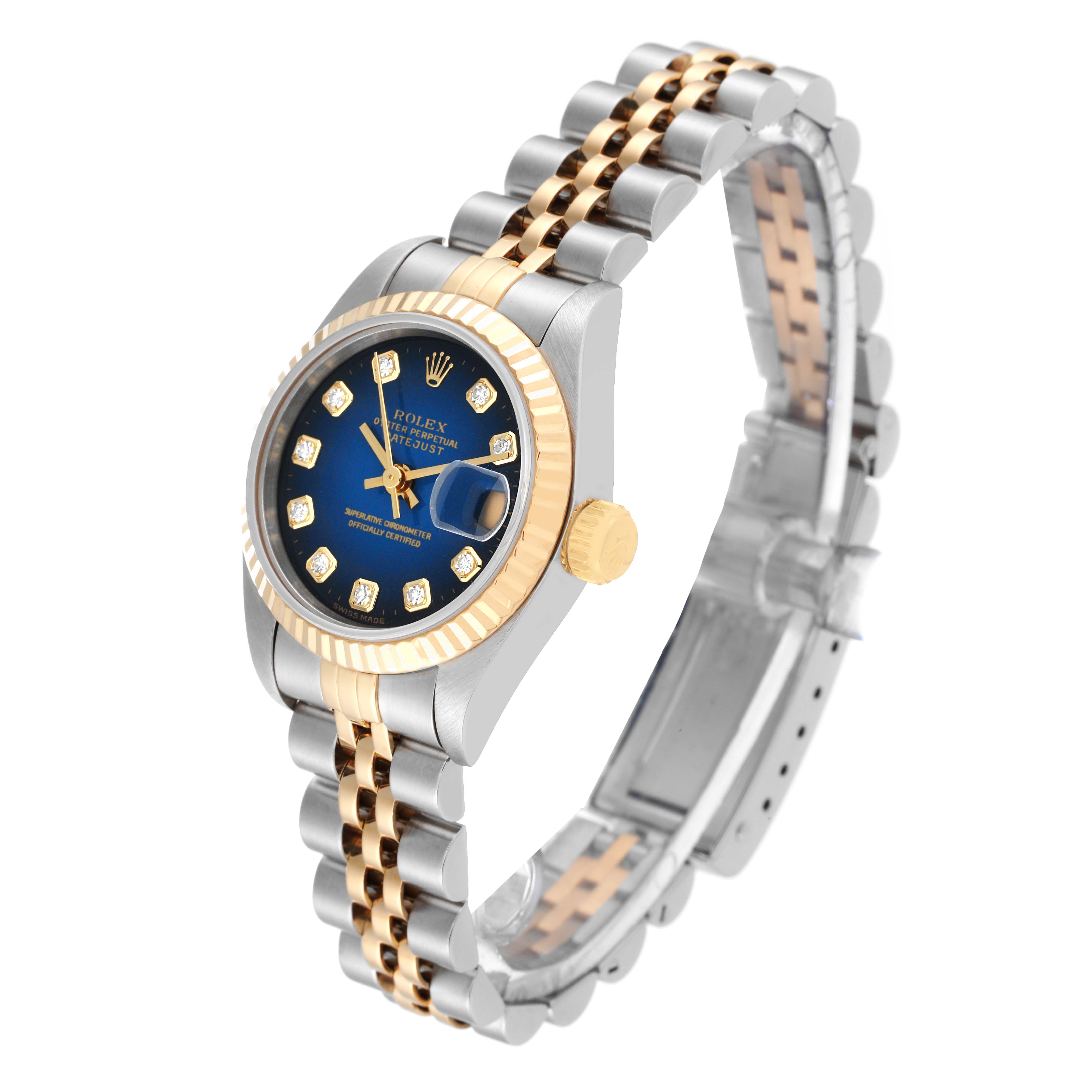 This Rolex Datejust 69173 Women's Steel and Gold (two tone) Blue Dial 69173 Women's Steel and Gold (two tone) Blue Dial watch is shown from an angled side view, highlighting its blue dial, gold bezel, crown, and two-tone bracelet.