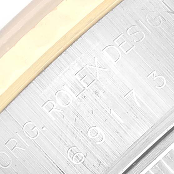 This image shows a close-up of the side engraving on a Rolex Datejust 69173 Women's Steel and Gold (two tone) Blue Dial 69173 Women's Steel and Gold (two tone) Blue Dial watch, featuring part of the model's serial number and design inscription.
