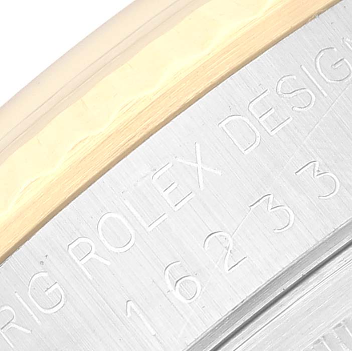 This image shows a close-up angle of the side with the engraved text and bezel of the Rolex Datejust 16233 Men's Steel and Gold (two tone) Champagne Dial 16233 Men's Steel and Gold (two tone) Champagne Dial model.