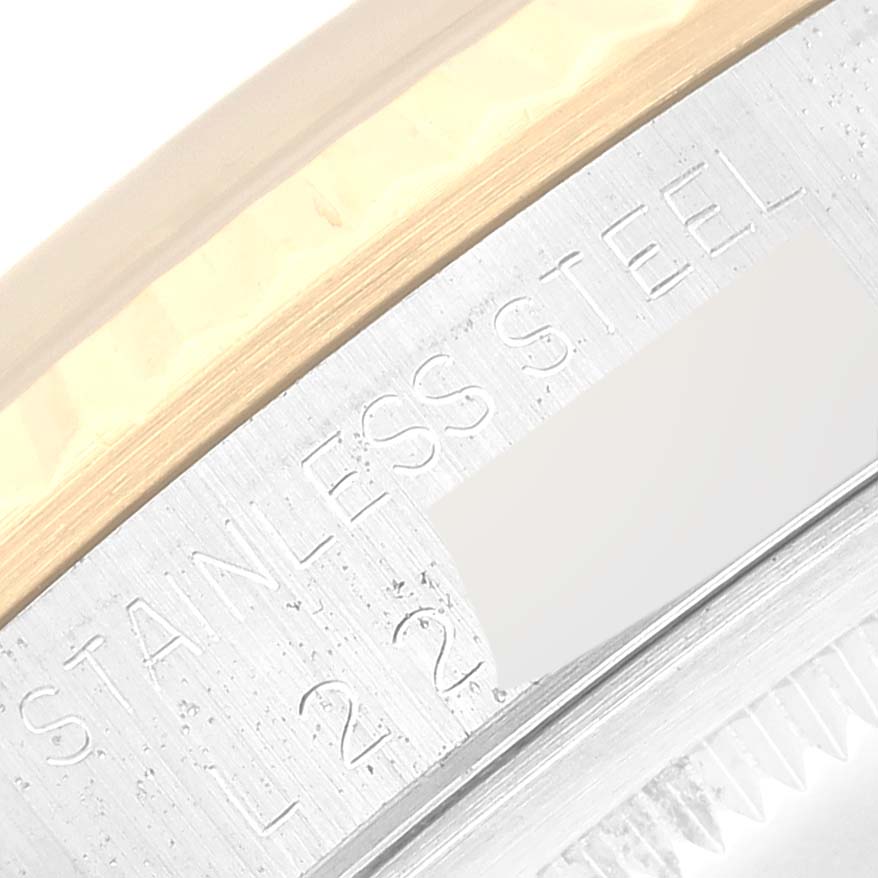 This image shows a close-up angle of the watch case and part of the bezel on a Rolex Datejust 16233 Men's Steel and Gold (two tone) Champagne Dial 16233 Men's Steel and Gold (two tone) Champagne Dial, highlighting the "STAINLESS STEEL" engraving.