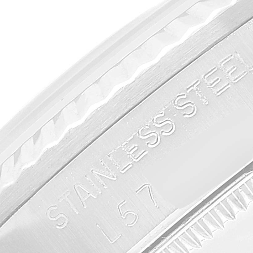 This image shows an engraved "Stainless Steel" detail on the Mid-Size Rolex watch caseback, viewed from a close-up angle.
