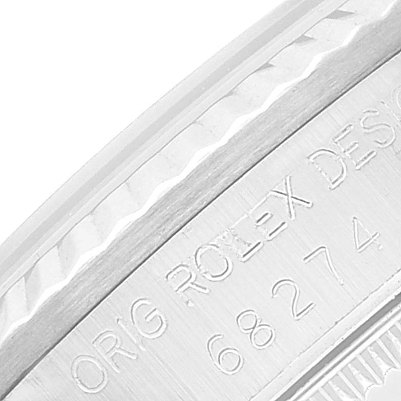 The image shows a close-up of the bezel and engraving on the case rim of a Rolex Mid-Size 68274 Women
s Stainless Steel White Dial 68274 Women
s Stainless Steel White Dial watch.