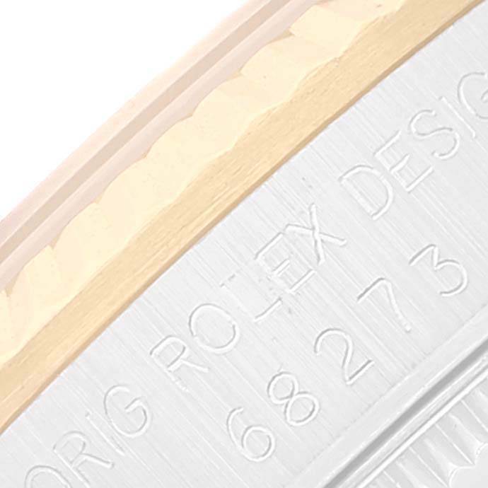 The image shows a close-up of the engraved serial number on the side of a Mid-Size Rolex watch.