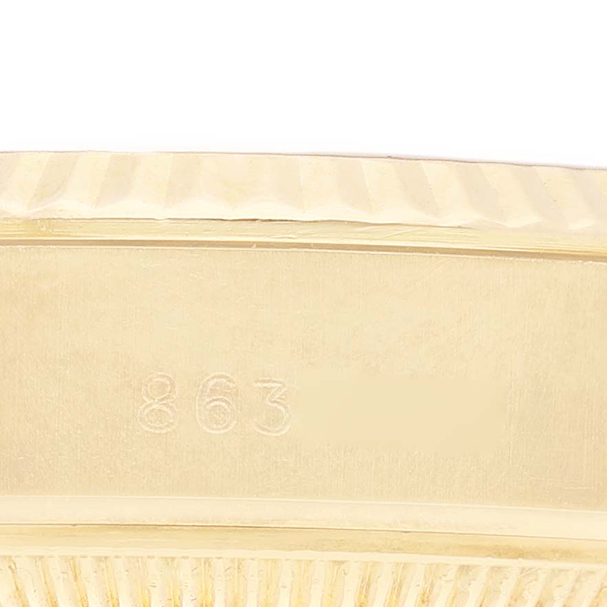 This close-up image shows the edge and detail of the bezel of a Rolex President 69178 Women's Yellow Gold Champagne Dial 69178 Women's Yellow Gold Champagne Dial model watch.