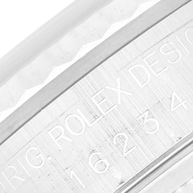 This image shows a close-up of the engraved bezel and inner case of a Rolex Datejust 16234 Men's Stainless Steel White Dial 16234 Men's Stainless Steel White Dial watch.