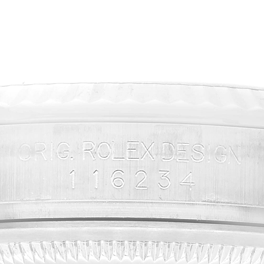 This image shows a close-up of the engraved inner case and bezel of a Rolex Datejust 116234 Men's Stainless Steel Pink Dial 116234 Men's Stainless Steel Pink Dial model.